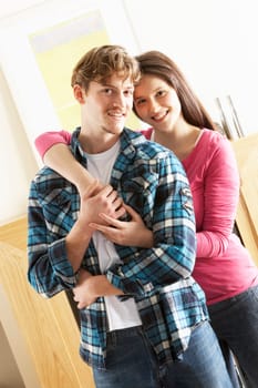 Romantic Young Couple Embracing In Living Room