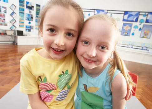 Two Female Primary Schoolchildren In Classroom