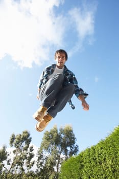 Young Man Jumping On Trampoline Caught In Mid Air