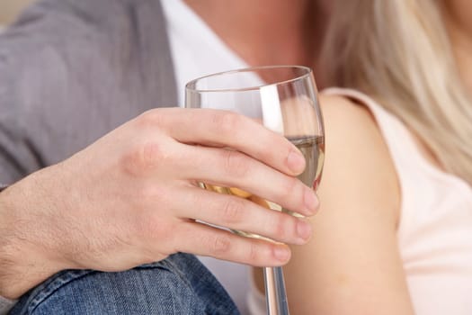 Close Up Of Hand Holding Glass Of White Wine