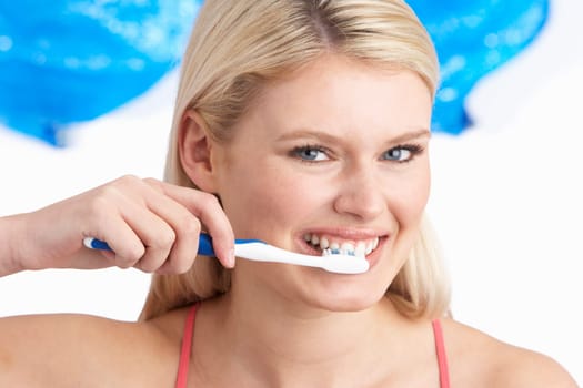 Young Woman Brushing Teeth In Studio