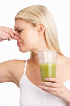 Young Woman Not Enjoying Healthy Drink In Studio
