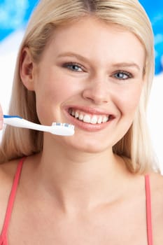 Young Woman Brushing Teeth In Studio