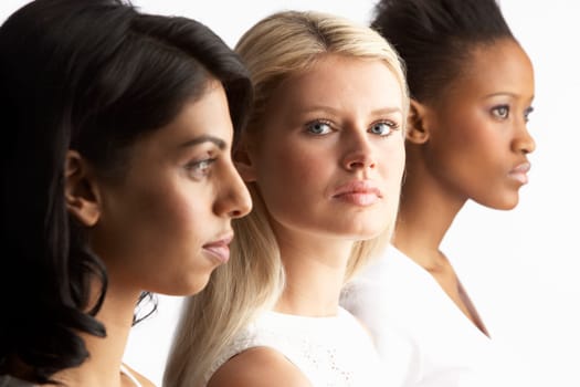 Portrait Of Three Attractive Young Women In Studio Standing In Line