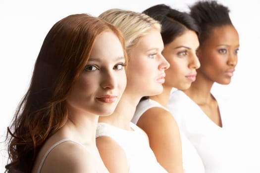 Portrait Of Four Attractive Young Women In Studio Standing In Line