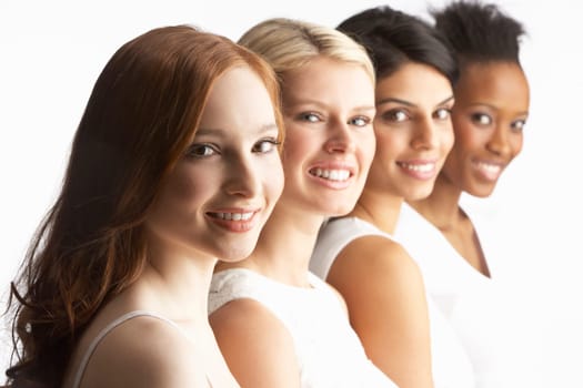 Portrait Of Four Attractive Young Women In Studio Standing In Line