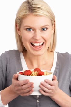 Young Woman Eating Bowl Of Healthy Breakfast Cereal In Studio