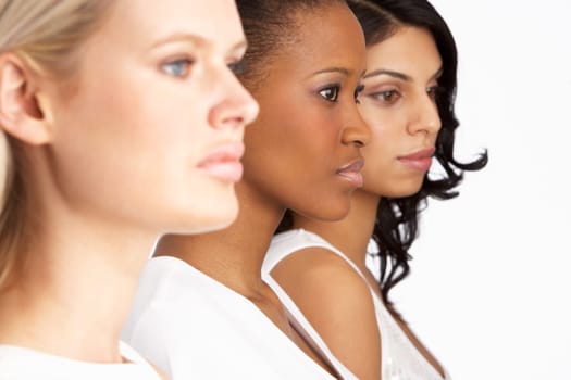 Portrait Of Three Attractive Young Women In Studio Standing In Line