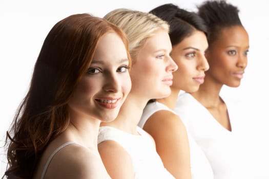 Portrait Of Four Attractive Young Women In Studio Standing In Line