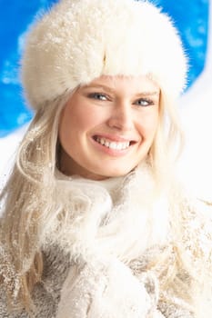 Young Woman Wearing Warm Winter Clothes And Fur Hat In Studio