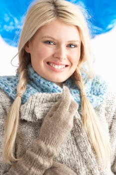 Pretty Young Woman Wearing Warm Winter Clothes In Studio