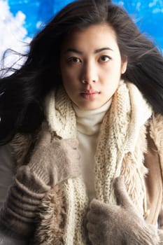 Young Woman Wearing Warm Winter Clothes In Studio