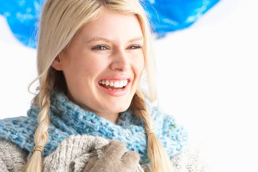 Pretty Young Woman Wearing Warm Winter Clothes In Studio