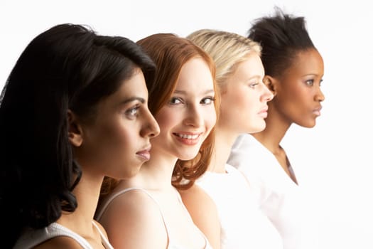 Portrait Of Four Attractive Young Women In Studio Standing In Line