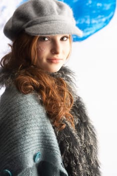 Fashionable Teenage Girl Wearing Cap And Knitwear In Studio
