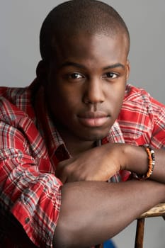 Fashionable Young Resting On Chair Man Wearing Casual Clothes In Studio