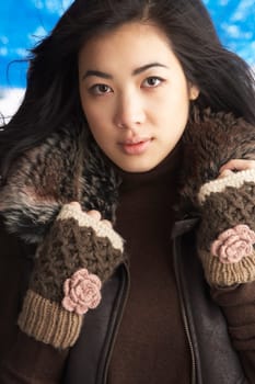 Young Woman Wearing Warm Winter Clothes In Studio