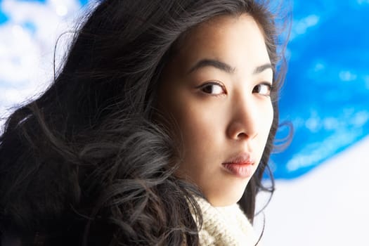 Young Woman Wearing Warm Winter Clothes In Studio