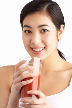 Young Woman Enjoying Healthy Drink In Studio