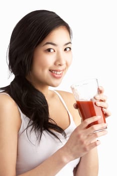 Young Woman Enjoying Healthy Drink In Studio