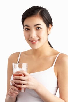 Young Woman Enjoying Healthy Drink In Studio