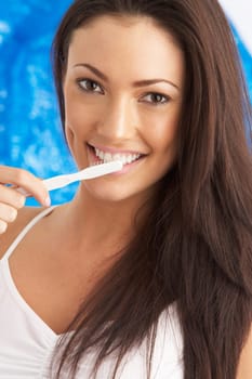 Young Woman Brushing Teeth In Studio