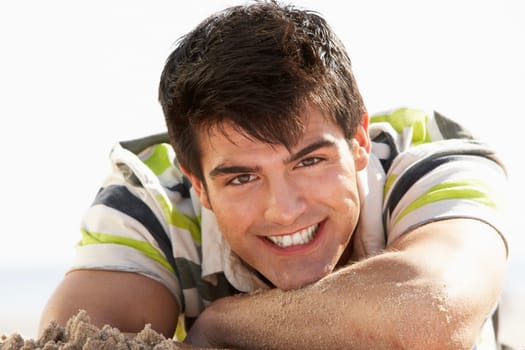 Teenage Boy Sitting On Beach
