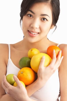 Young Woman Holding Citrus Fruit In Studio