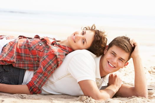 Romantic Young Couple Relaxing On Beach