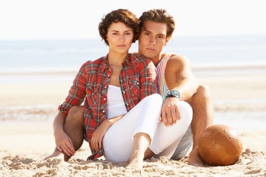 Romantic Young Couple Relaxing On Beach