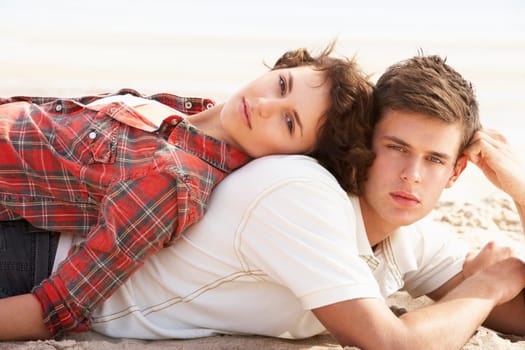 Romantic Young Couple Relaxing On Beach