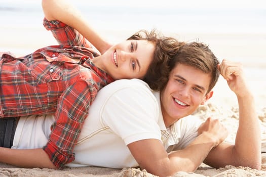 Romantic Young Couple Relaxing On Beach