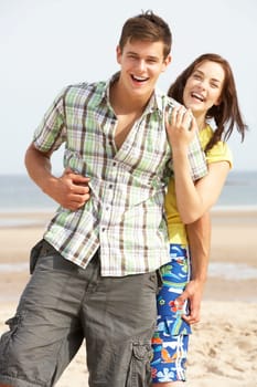 Romantic Teenage Couple Embracing On Beach