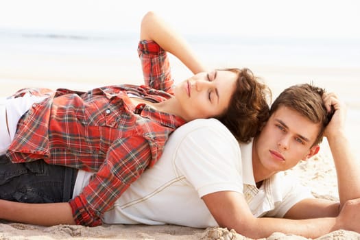 Romantic Young Couple Relaxing On Beach