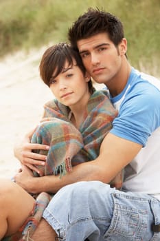 Romantic Young Couple Embracing On Beach