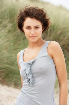 Attractive Young Woman Kneeling Amongst Sand Dunes