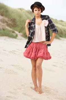 Fashionably Dressed Attractive Young Woman Standing Amongst Sand Dunes