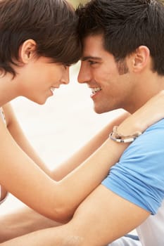 Romantic Young Couple Embracing On Beach