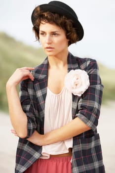 Fashionably Dressed Attractive Young Woman Standing Amongst Sand Dunes