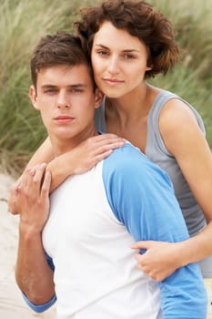 Romantic Young Couple Embracing On Beach