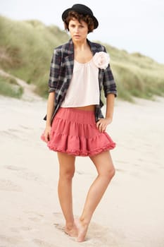 Fashionably Dressed Attractive Young Woman Standing Amongst Sand Dunes