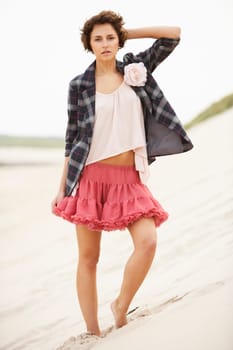 Fashionably Dressed Attractive Young Woman Standing Amongst Sand Dunes