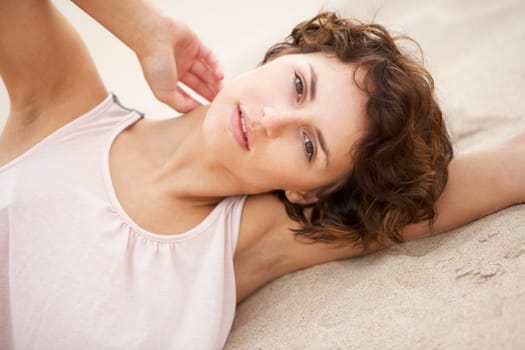 Fashionably Dressed Attractive Young Woman Laying Amongst Sand Dunes