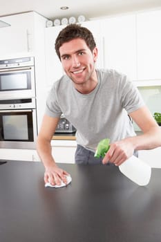 Young Man Cleaning Modern Kitchen