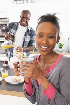 Young Couple Preparing Breakfast In Modern Kitchen