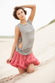 Attractive Young Woman Wearing Revealing Clothing Standing Amongst Sand Dunes