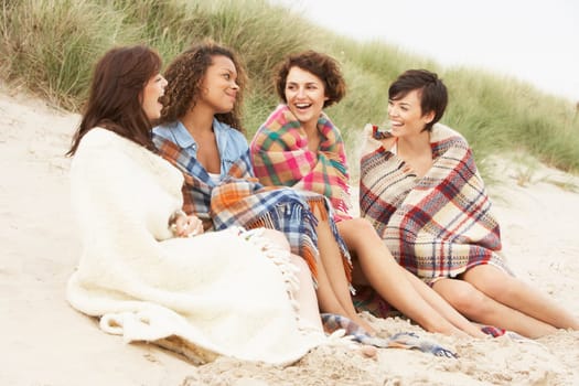 Group Of Girls Sitting On Beach Together