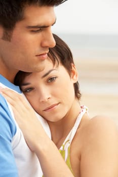 Romantic Young Couple Embracing On Beach