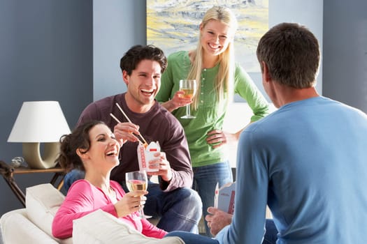 Group Of Friends Enjoying Chinese Takeaway Meal At Home