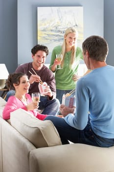 Group Of Friends Enjoying Chinese Takeaway Meal At Home
